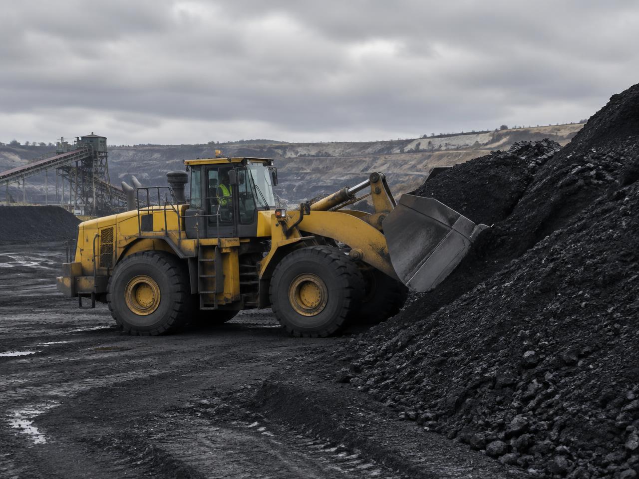 A wheel loader working a coal stockpile at a mine